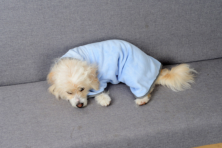 Dog lying down in the Harbor Blue drying robe after a bath
